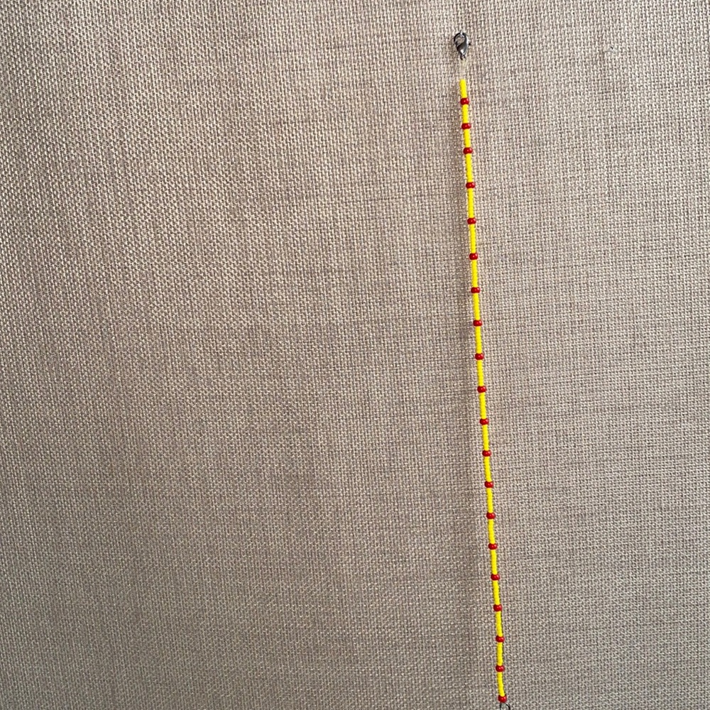 A choker necklace, with yellow and red beads